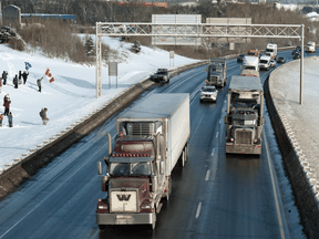 Trucks move on the TransCanada Highway heading to Ottawa to protest against COVID-19 restrictions, January 28, 2022  in Levis, Que.