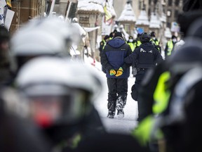 Police from all different forces across the country joined together to try to bring the "Freedom Convoy" occupation to an end Saturday, February 19, 2022. A protester was removed in handcuffs Saturday morning.