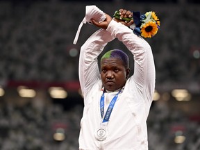 USA's Raven Saunders gestures on the podium with her silver medal after competing in the women's shotput event during the Tokyo 2020 Olympic Games at the Olympic Stadium in Tokyo on August 1, 2021.