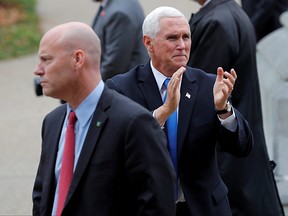 U.S. Vice President Mike Pence reacts to supporters outside the New Hampshire State House as he walks near his Chief of Staff Marc Short, left, at a 2019 event.