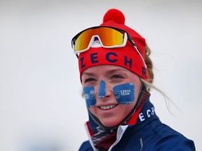 A Team Czech Republic protects her face from the wind and cold during her biathlon training session last week.