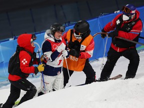Kai Owens of Team United States is checked on by medical staff after a crash during the Women's Freestyle Skiing Moguls training session ahead of Beijing 2022 Winter Olympic Games at the Genting Snow Park on February 01, 2022 in Zhangjiakou, China.