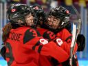 Sarah Nurse #20 of Team Canada is congratulated by Erin Ambrose #23 and Jocelyne Larocque #3 after scoring a goal against Team Finland.