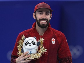 Silver medallist Steven Dubois of Team Canada poses with a Bing Dwen Dwen mascot during the Men's 1500m Final A flower ceremony on day five of the Beijing 2022 Winter Olympic Games at Capital Indoor Stadium on Feb. 09 in Beijing, China.
