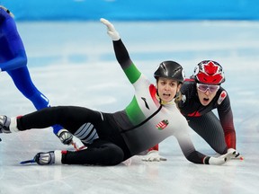 Florence Brunelle of Canada and Zsofia Konya of Hungary fall during final of mixed relay short track speed skating.