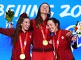 Gold medallists Ivanie Blondin, Valerie Maltais and Isabelle Weidemann of Team Canada pose with their medals during the Women's Team Pursuit medal ceremony on Day 11 of the Beijing 2022 Winter Olympic Games at Beijing Medal Plaza.