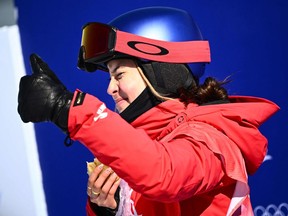 China's Gu Ailing Eileen gestures as she waits for her score in the freestyle skiing women's freeski slopestyle qualification run during the Beijing 2022 Winter Olympic Games at the Genting Snow Park H & S Stadium in Zhangjiakou on February 14, 2022.