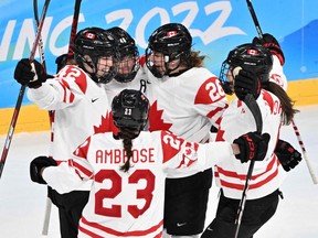 Canada's players celebrate their third goal during the women's playoffs semifinal match against Switzerland in the Beijing 2022 Winter Olympic Games on Feb. 14, 2022.