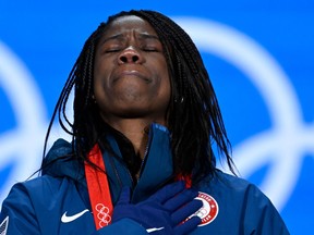 Gold medallist USA's Erin Jackson reacts on the podium during the women's 500m speed skating victory ceremony of the Beijing 2022 Winter Olympic Games at the Beijing Medals Plaza in Beijing on February 14, 2022.