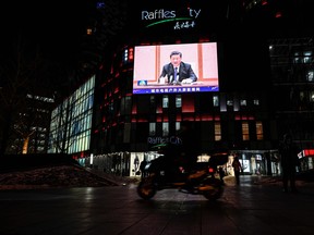 Chinese President Xi Jinping is seen in an outdoor screen during a news program broadcasting his meeting with President of the International Olympic Committee (IOC) Thomas Bach in Beijing on January 25, 2022, ahead of the Beijing 2022 Winter Olympic and Paralympic Games. (Photo by JADE GAO / AFP) (Photo by JADE GAO/AFP via Getty Images)