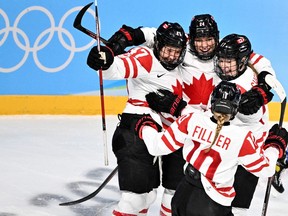 Canada's Jamie Lee Rattray (L) celebrates with teammates after scoring the goal during the women's preliminary round group A match of the Beijing 2022 Winter Olympic Games ice hockey competition between USA and Canada, at the Wukesong Sports Centre in Beijing on February 8, 2022