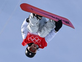 Japan's Ayumu Hirano competes in the snowboard men's halfpipe final run during the Beijing 2022 Winter Olympic Games on Feb. 11, 2022. Controversy erupted over Hirano's second-place score on one of his runs despite the fact he had made Olympic history by landing a frontside triple cork. He ultimately won gold.