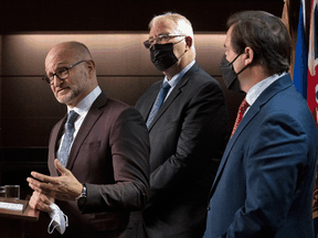 Left to right, Justice Minister David Lametti, Emergency Preparedness Minister Bill Blair and Public Safety Minister Marco Mendicino during a news conference on Wednesday, February 16, 2022 in Ottawa.