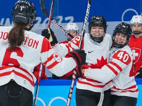 Canada’s from left; Canada’s Rebecca Johnston, Claire Thompson and Blayre Turnbull celebrate a goal one of five in the first period of their semi-final match against Switzerland at the Beijing 2022 Winter Olympics on Monday, February 14, 2022.