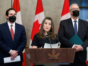 Minister of Finance Chrystia Freeland announces orders related to the invocation of the Emergencies Act on Thursday while Canada's Minister of Public Safety Marco Mendicino, and Canada's Minister of Emergency Preparedness Bill Blair, listen.