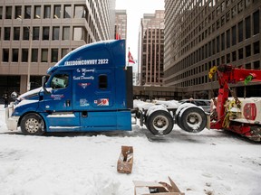 A truck is towed from Kent Street, as Canadian police worked to evict the last of the trucks and supporters occupying the downtown core, three weeks after a protest against coronavirus disease (COVID-19) vaccine mandates began in Ottawa, Ontario, Canada, February 20, 2022.