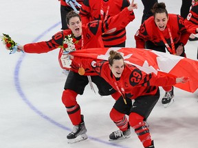 Team Canada celebrates with their gold medals after downing the USA 3-2 in women’s hockey at the Beijing 2022 Winter Olympics.