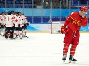 Taile Wang of Team China reacts to defeat during the Men's Ice Hockey Preliminary Round Group A match between Team China and Team Canada.