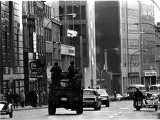 An army truck loaded with soldiers rolls through Montreal's financial district during the October Crisis of 1970.