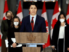 Prime Minister Justin Trudeau with Foreign Affairs Minister Mélanie Joly, Deputy Prime Minister Chrystia Freeland and National Defence Minister Anita Anand at a news conference about the situation in Ukraine, February 24, 2022 in Ottawa.