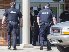 Police enter the Church of God Restoration in Aylmer, Ont., on May 14, 2021, after a judge ordered the doors padlocked to prevent church gatherings.  The Church of God and Waterloo's Trinity Bible Chapel are arguing in the Ontario Superior Court that they shouldn’t be fined for violating restrictions on religious gatherings that were meant to curb the transmission of COVID-19.