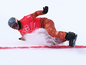 Eliot Grondin of Team Canada crosses the finish line to win the silver medal during the Men's Snowboard Cross Final on Day 6 of the Beijing 2022 Winter Olympics.