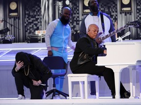 Eminem takes a knee during the halftime show as Dr. Dre looks on REUTERS/Mike Segar