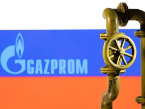 Illustration shows Gazprom logo and Russian flag