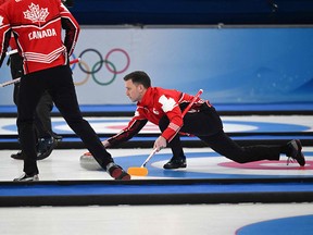 Canada's Brad Gushue curls the stone during the men's round robin session 12 game of the Beijing 2022 Winter Olympic Games.