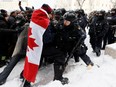 Police officers face off with protesters in Ottawa, on Feb. 19.