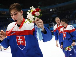 Juraj Slafkovsky #20 of Team Slovakia holds up the Bronze Medal after the Men's Ice Hockey Bronze Medal match between Team Sweden and Team Slovakia on Day 15 of the Beijing 2022 Winter Olympic Games.