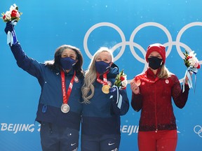 Gold medallist Kaillie Humphries of Team United States (C), Silver medallist Elana Meyers Taylor of Team United States, (L) and Bronze medallist Christine de Bruin of Team Canada (R) after winning medals in the Olympic monobob.