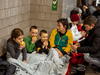 A family sits in the Kyiv subway, using it as a bomb shelter in Kyiv, Ukraine, Friday, Feb. 25, 2022.