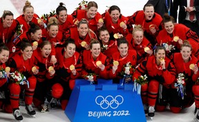 Gold medallist Team Canada players pose with their gold medals. REUTERS/David W Cerny