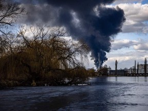 Smoke billows over the town of Vasylkiv just outside Kyiv on February 27, 2022, after overnight Russian strikes hit an oil depot.