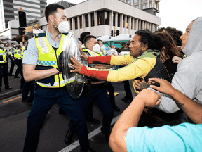 Police and protesters clash Tuesday in Wellington as police tightened a cordon around a convoy camped outside Parliament for two weeks.