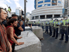 Riot police form a line in front of the parliament building in Wellington, New Zealand, on February 22, 2022, as anti-vaccine protesters occupy the streets and grounds outside.