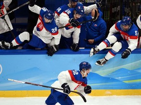 Slovakia's hockey players leap from the benches after victory in their quarterfinal game against the United States at the 2022 Beijing Olympics on Feb. 16.
