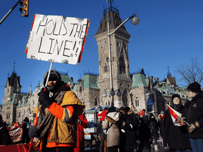 Truck drivers and their supporters block streets during a protest against COVID-19 restrictions, near the parliament buildings in Ottawa on February 15, 2022.