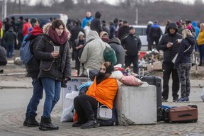 Ukrainian citizens arriving at the Medyka pedestrian border crossing fleeing conflict in their country, eastern Poland, on February 27, 2022. (Photo by WOJTEK RADWANSKI/AFP via Getty Images)