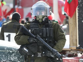 An officer takes part in the operation to remove the Freedom Convoy protest from downtown Ottawa on Feb. 18, 2022.