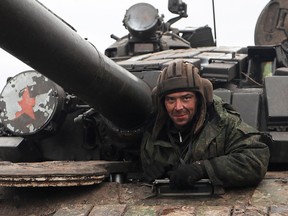 A member of a pro-Russian militia mans a tank on a road in the Luhansk region of Ukraine on Feb. 27, 2022.