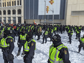 Police confront protesters near the Rideau Centre in Ottawa on February 18, 2022.