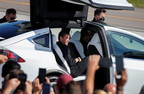 Jared Isaacman, founder and CEO of Shift4 Payments and flight commander, climbs into a Tesla on his way to the Falcon 9 rocket pad at Cape Canaveral.