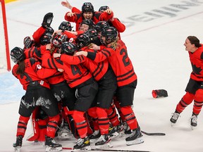 Team Canada celebrates winning the gold medal in women’s hockey at the Beijing 2022 Winter Olympics.