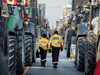 Toronto police officers walk through farm tractors just north of Queens Park as farmers and truckers have started to arrive to protest against COVID-19 restrictions, February 4, 2022.