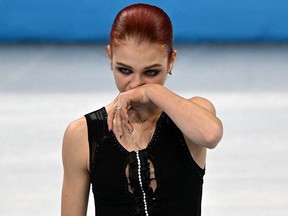 Russian silver medalist Alexandra Trusova reacts on the podium in the women's figure skating event during the 2022 Winter Olympics in Beijing.