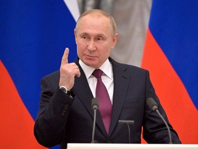 Russian President Vladimir Putin gestures during a joint news conference with German Chancellor Olaf Scholz in Moscow, Russia February 15, 2022. Sputnik/Sergey Guneev/Pool via REUTERS