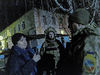 Ukrainian soldiers talk with a local resident outside of a kindergarten, which, according to military officials, was damaged by shelling, in Stanytsia Luhanska, Ukraine, February 17, 2022.