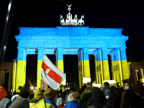 The Brandenburg Gate in Berlin, Germany, is lit up in the colours of the Ukrainian flag. Similar gestures of support for Ukraine are happening at city landmarks around the world.